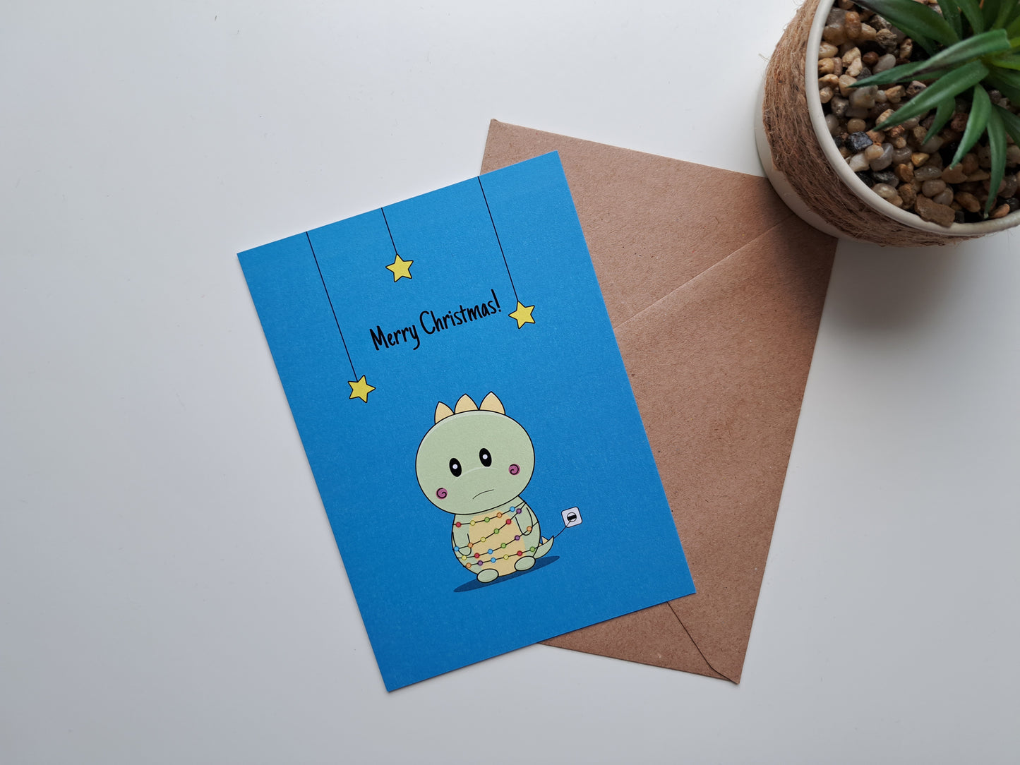 Christmas greeting card with Dinosaur caught in lights