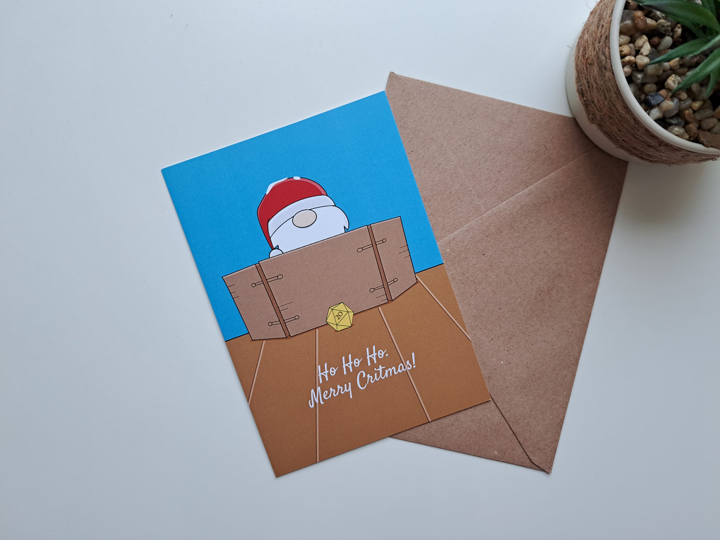 Christmas greeting card with Santa Dungeon master and a d20 rolled on table