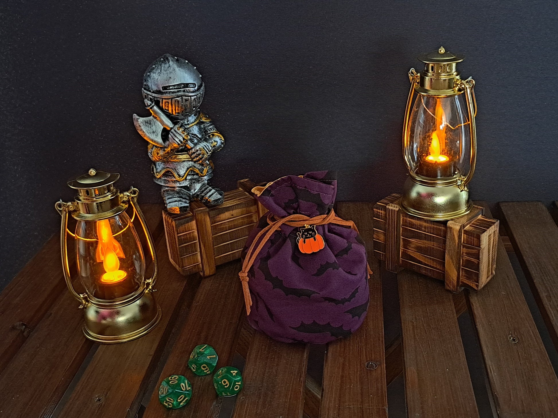 Handmade Dice bag made of purple fabric with black bats on it with a pumpkin charm