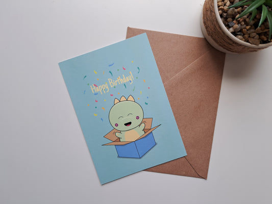 Birthday greeting card with Dinosaur jumping out of box