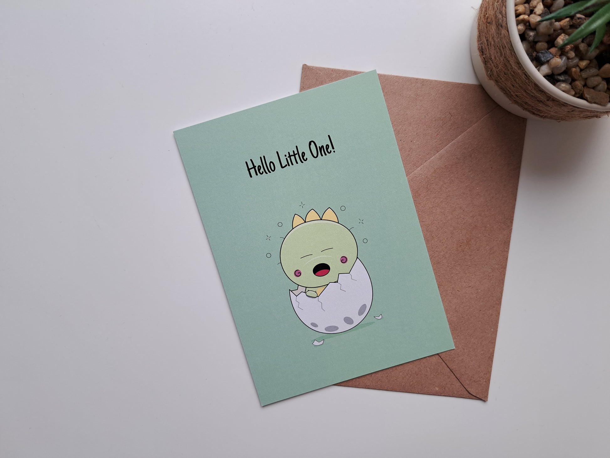 New baby greeting card  where Dinosaur baby is waking up from his egg