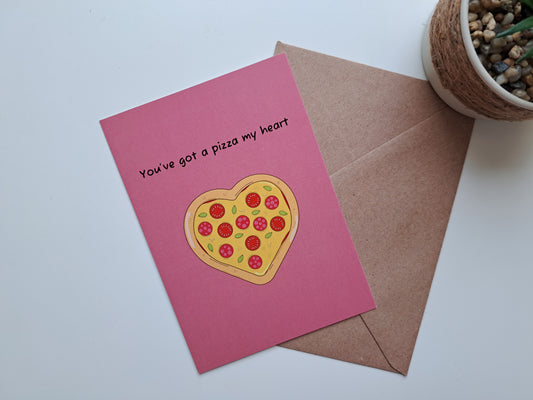 Valentine's day greeting card with a pizza in the shape of a heart