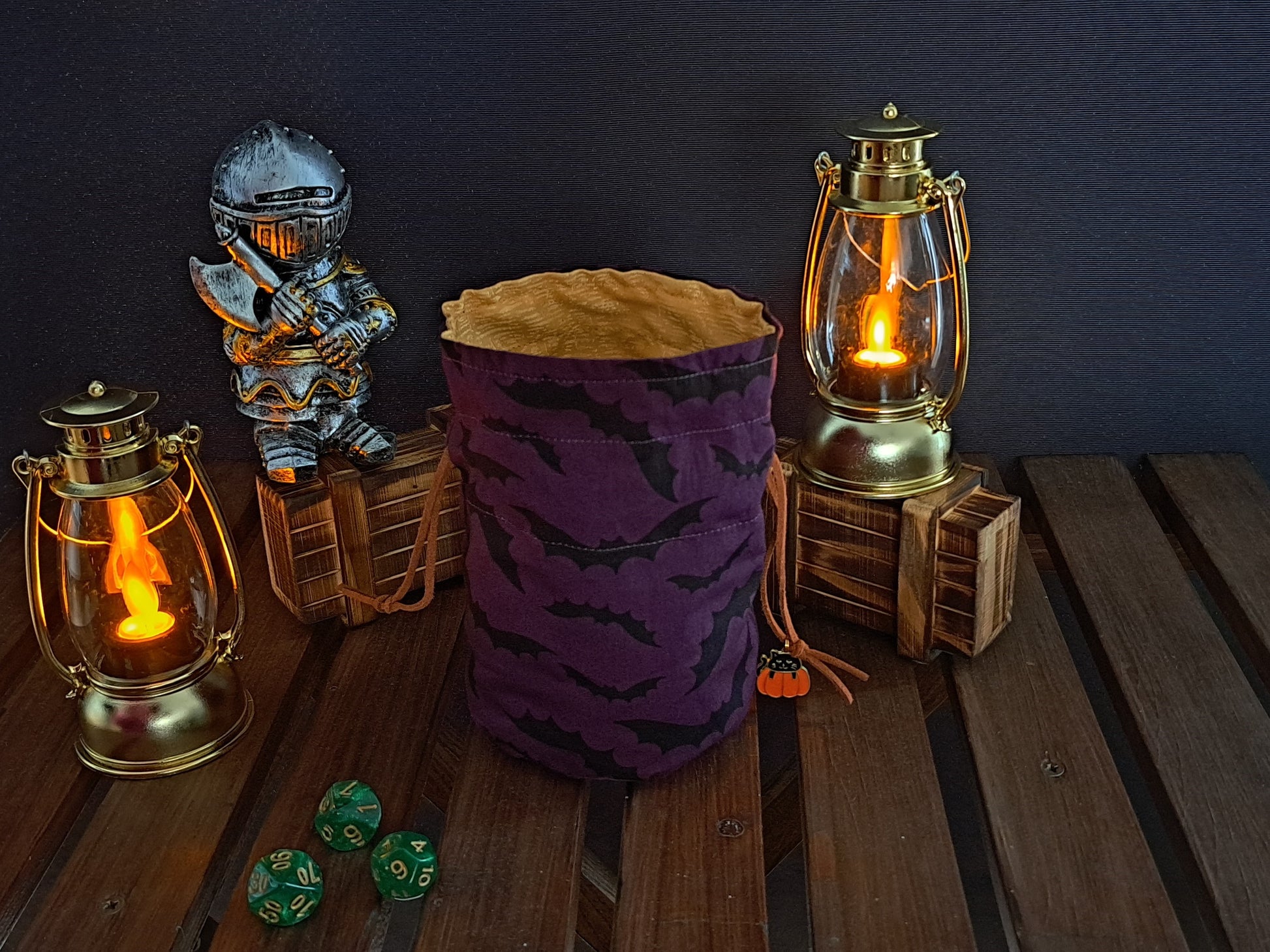 Handmade Dice bag made of purple fabric with black bats on it with a pumpkin charm